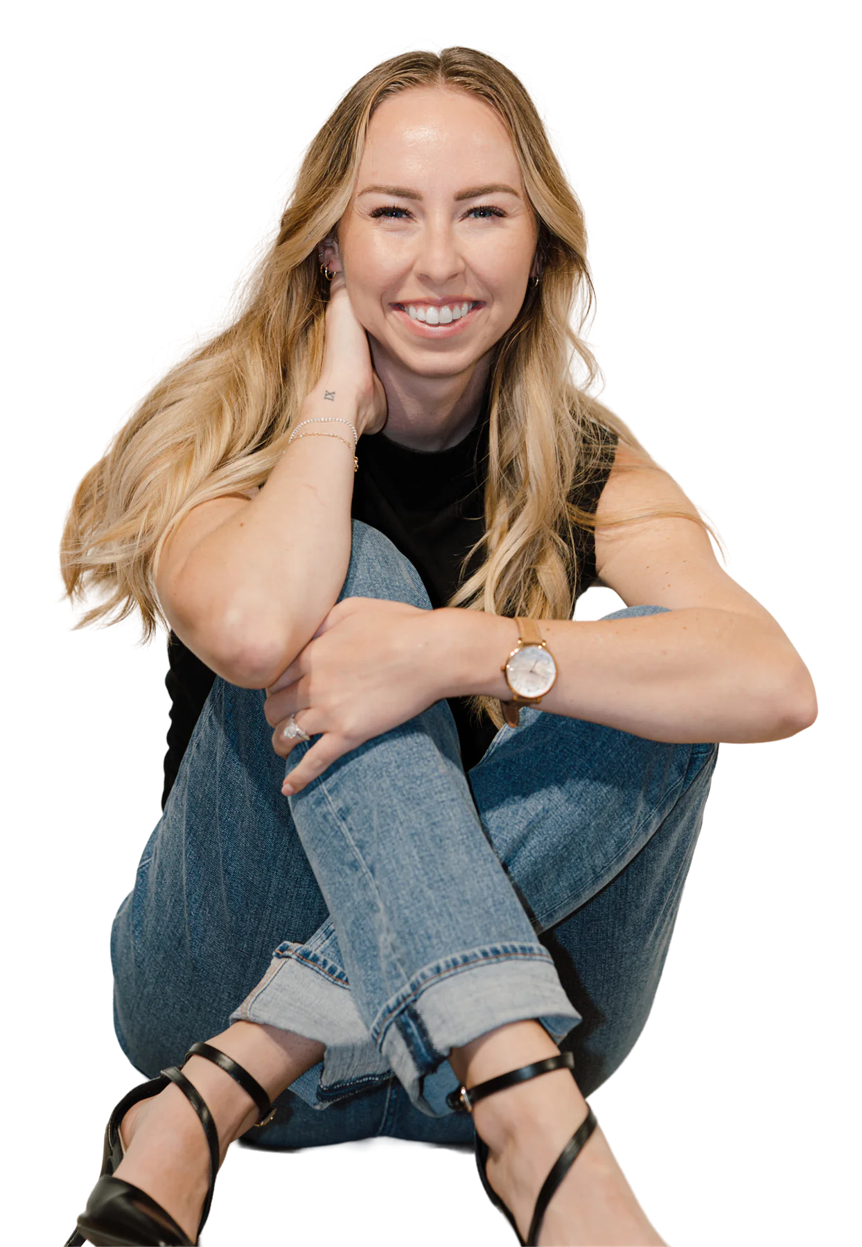 Lillie, seated and smiling, with long blonde waves